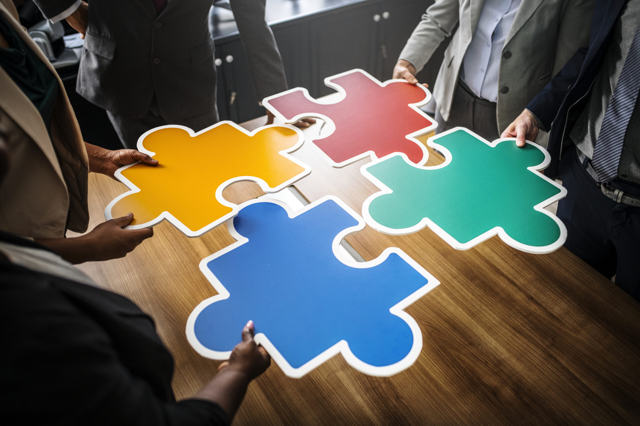 Business people connecting puzzle pieces